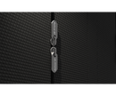 Close-up of a black textured suitcase with a brand tag.