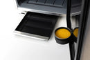 Close-up of a refrigerator with a black interior light on a white background