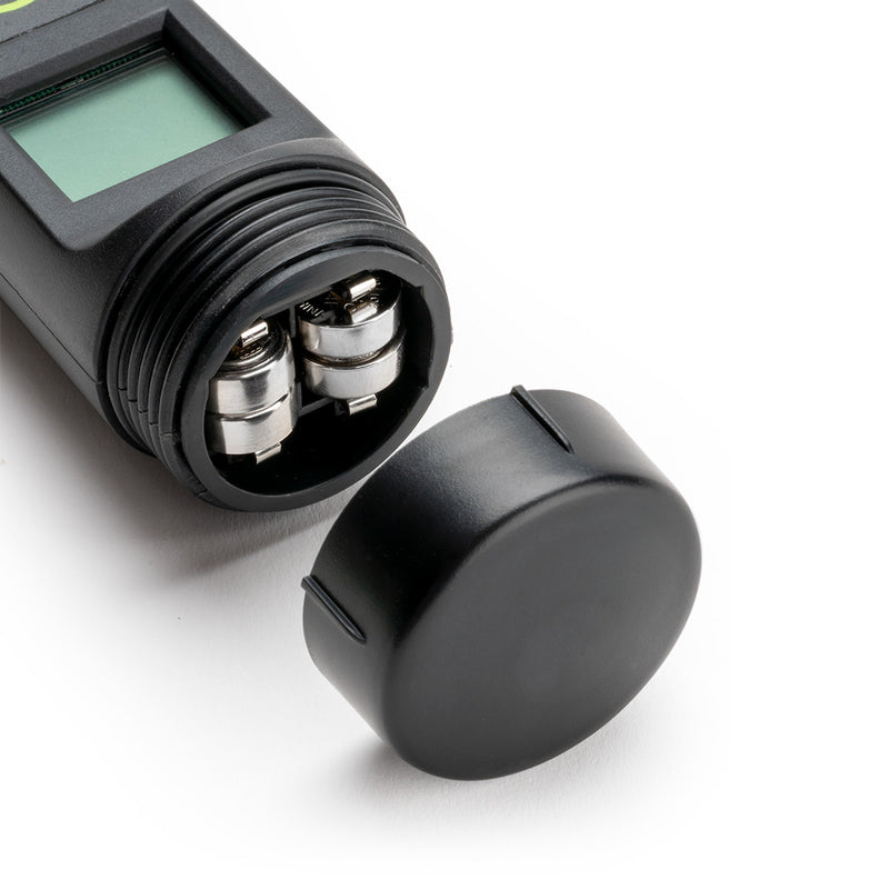Black electronic device with a digital display and cylindrical components on a white background