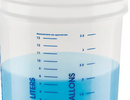 Measuring cup with blue liquid and measurement markings on a white background
